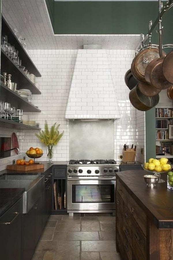 You can extend the tiles onto the ceiling and even onto the kitchen hood