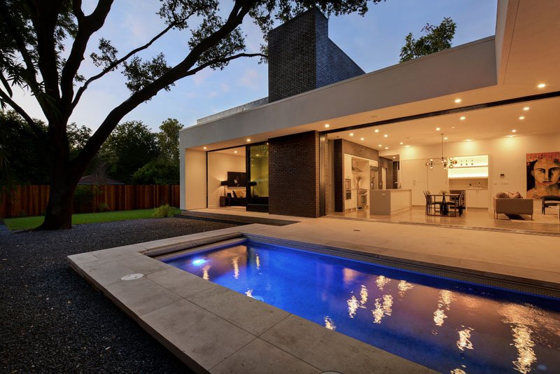 contemporary house design with pool facing living space
