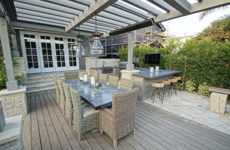 Traditional outdoor deck with wooden pergola and hanging lights