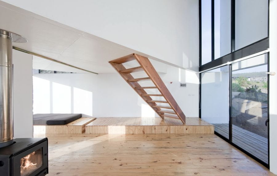 double height volume with floating wooden stair in cube home